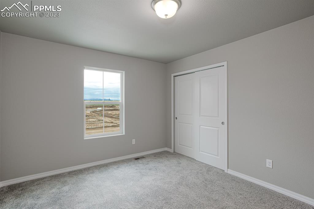 4336 Samaritan Loop Colorado Springs, CO 80916 - Photo 20 of 22 an empty room with windows
