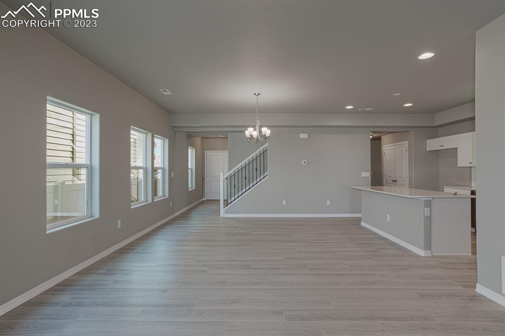 4336 Samaritan Loop Colorado Springs, CO 80916 - Photo 7 of 22 an empty room with wooden floor and windows