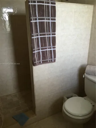a white toilet sitting next to a bathroom sink