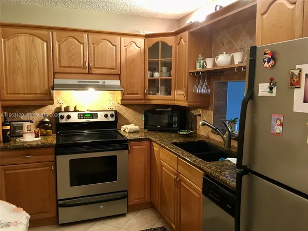 a kitchen with a stove and a refrigerator