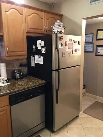 a white refrigerator freezer sitting in a kitchen
