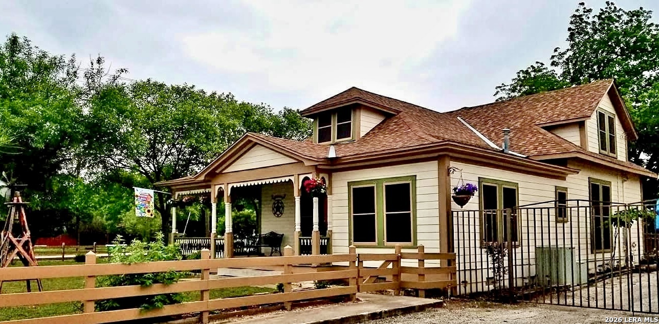 a view of a brick house with many windows next to a yard