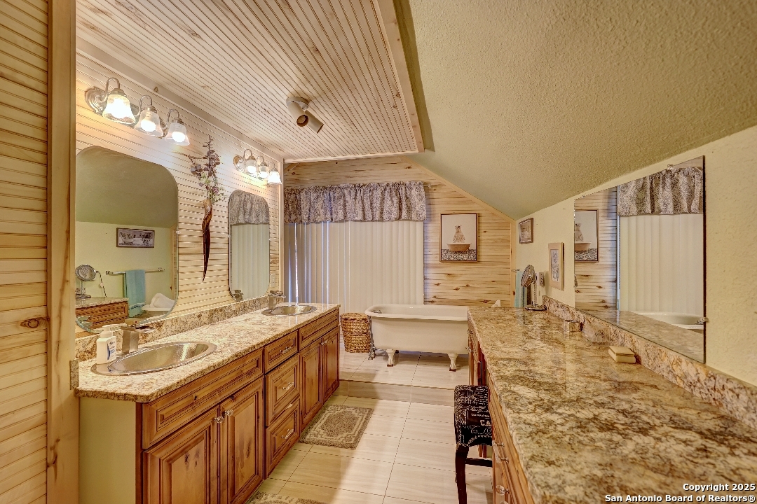 101 North 11th Street Junction, TX 76849 - Photo 14 of 26 a spacious bathroom with a bathtub and a shower