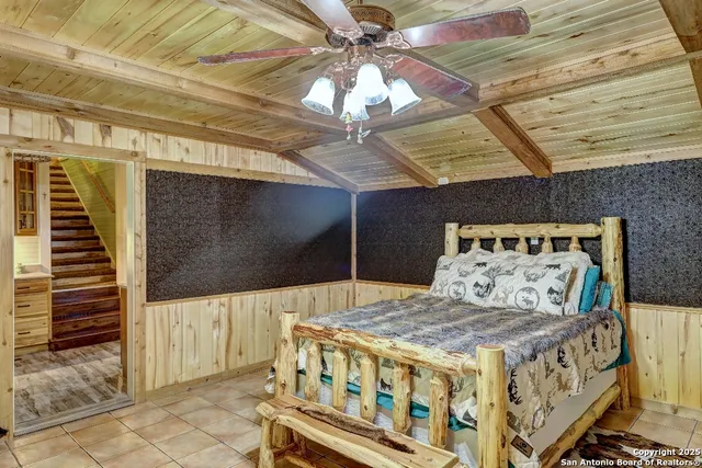 a bedroom with a bed and a mirror on the dresser