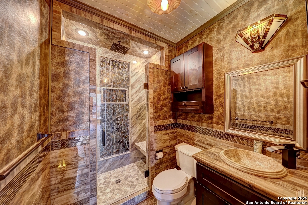 101 North 11th Street Junction, TX 76849 - Photo 18 of 26 a bathroom with a granite countertop bathtub sink vanity mirror and toilet