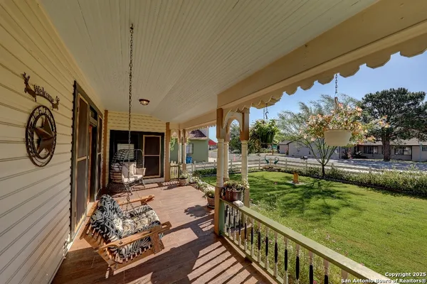 a view of a porch with furniture and garden