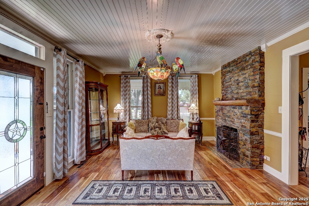 101 North 11th Street Junction, TX 76849 - Photo 5 of 26 a living room with fireplace furniture and a chandelier