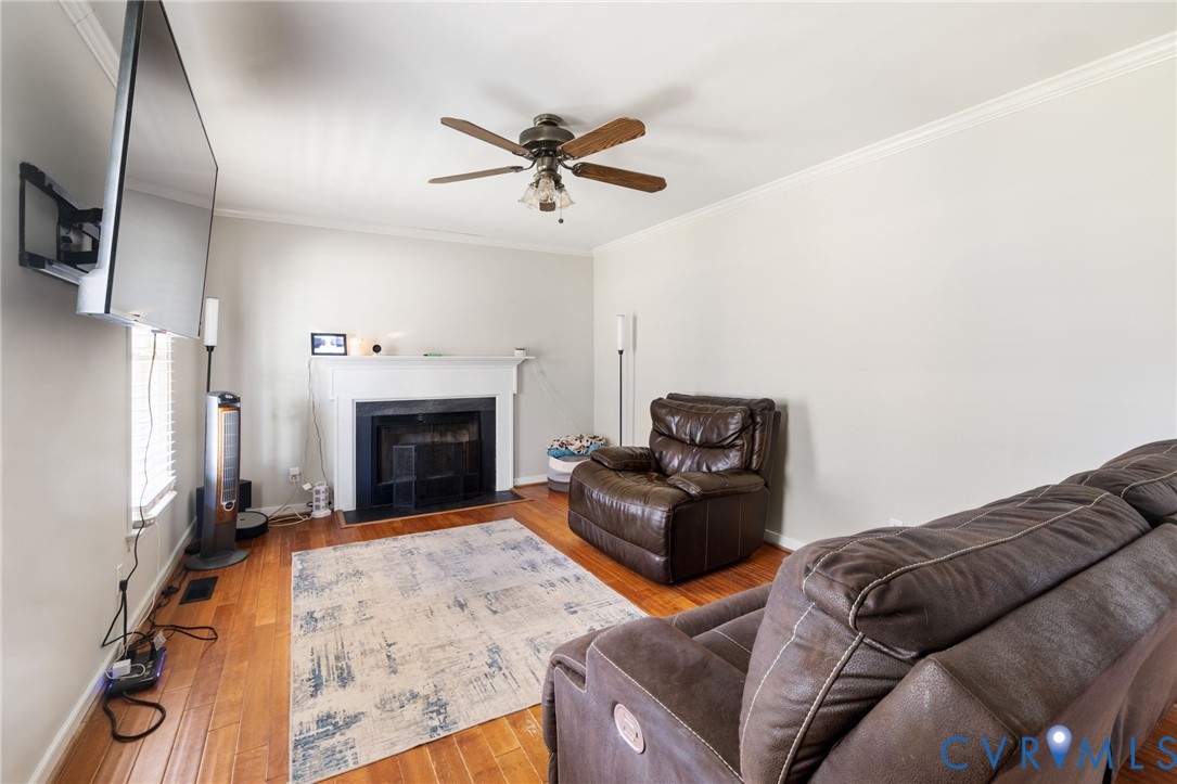 2015 Oneida Road Powhatan, VA 23139 - Photo 19 of 24 Living area featuring crown molding, hardwood / wo