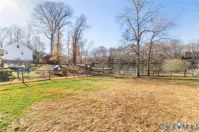 a view of yard with swimming pool and trees