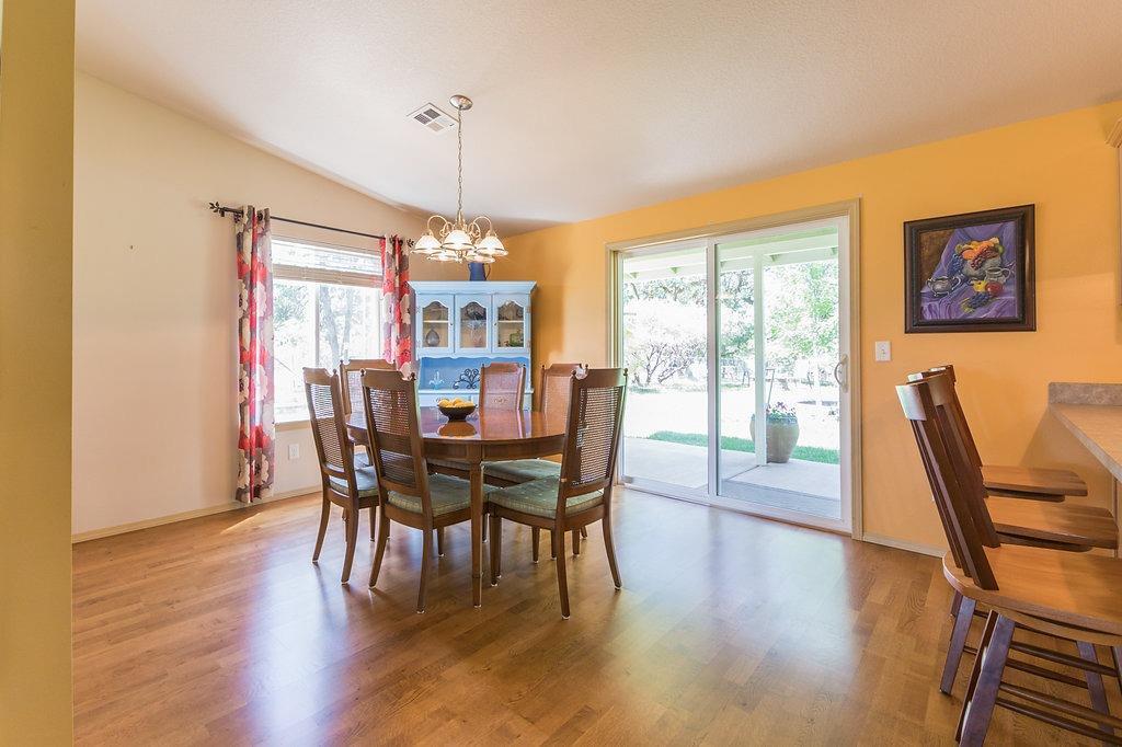 12622 Perry Road White City, OR 97503 - Photo 11 of 29 a view of a dining room with furniture window and wooden floor