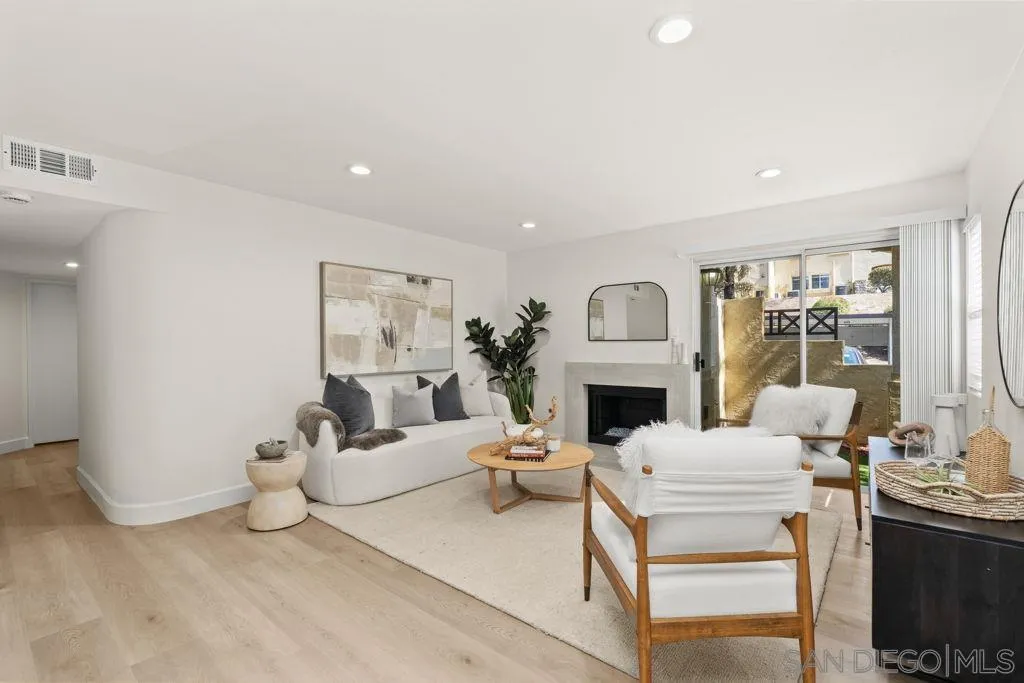 761 Brookstone Road, Unit 102 Chula Vista, CA 91913 - Photo 11 of 34 a living room with furniture a fireplace and a chandelier
