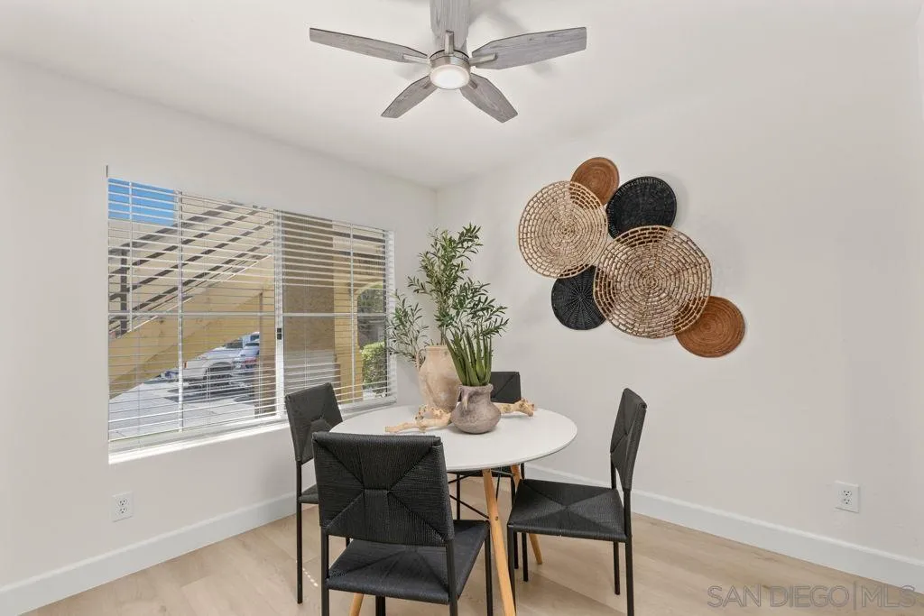761 Brookstone Road, Unit 102 Chula Vista, CA 91913 - Photo 13 of 34 a dining room with a large window table and chairs