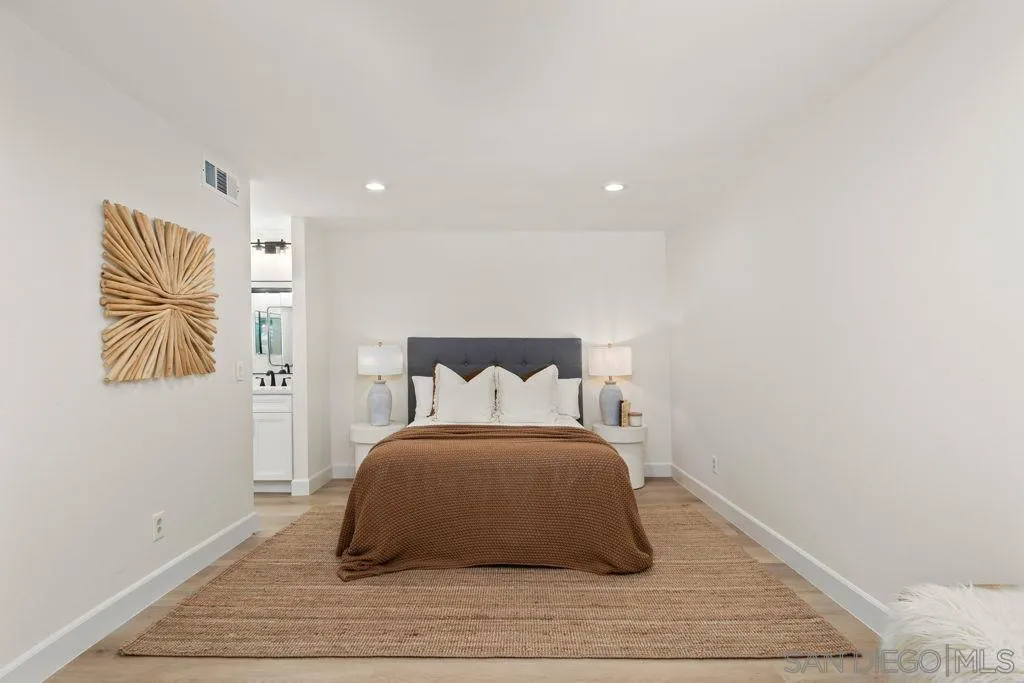 761 Brookstone Road, Unit 102 Chula Vista, CA 91913 - Photo 18 of 34 a bedroom with a bed and night stand