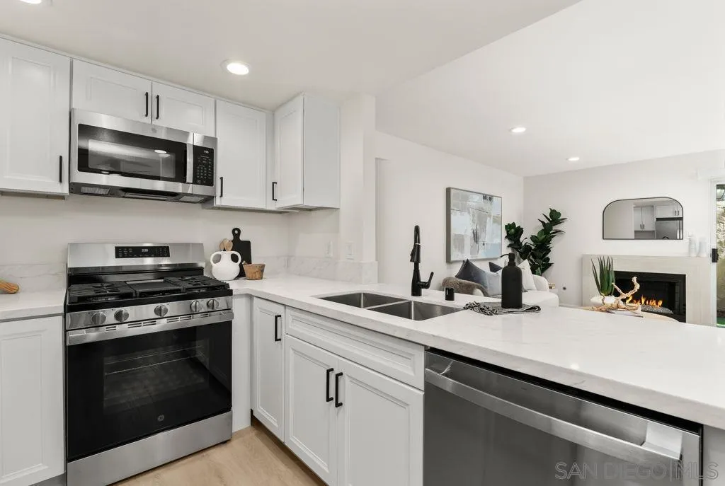 761 Brookstone Road, Unit 102 Chula Vista, CA 91913 - Photo 4 of 34 a kitchen with cabinets stainless steel appliances and a sink