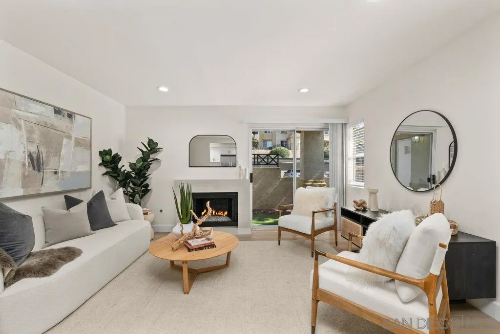 761 Brookstone Road, Unit 102 Chula Vista, CA 91913 - Photo 10 of 34 a living room with furniture a mirror and a fireplace