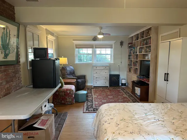 a bedroom with furniture and a window
