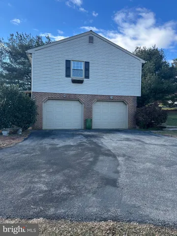 a front view of house with backyard