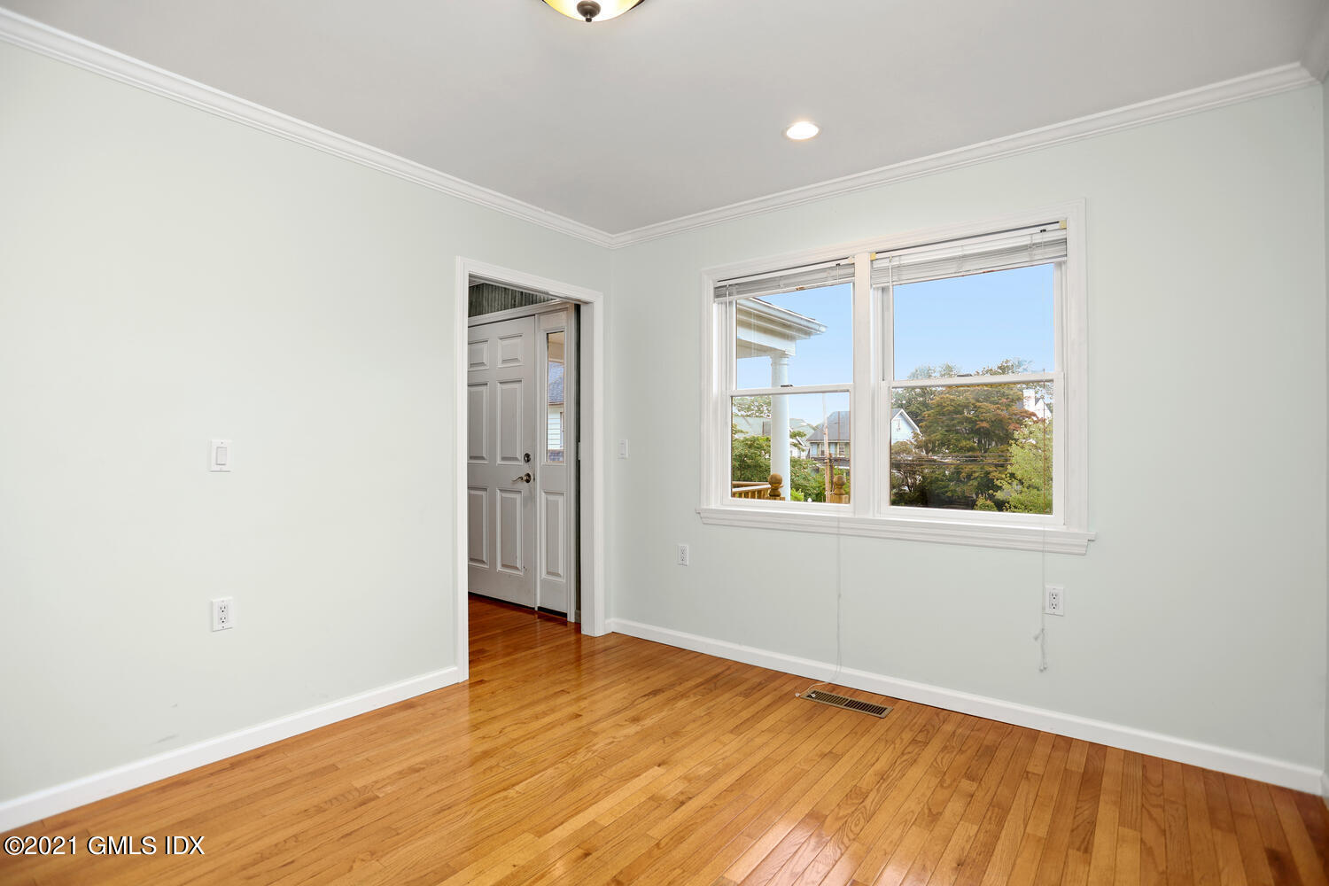 284 Glenbrook Road Stamford, CT 06906 - Photo 13 of 45 an empty room with wooden floor and windows