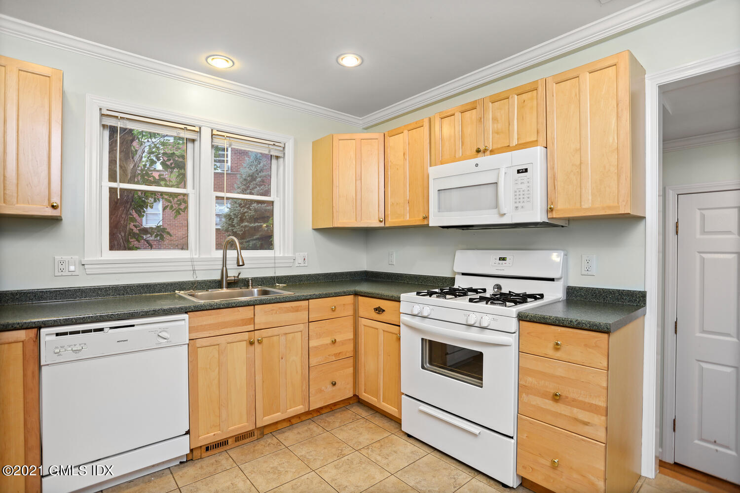 284 Glenbrook Road Stamford, CT 06906 - Photo 16 of 45 a kitchen with cabinets appliances a sink and a window