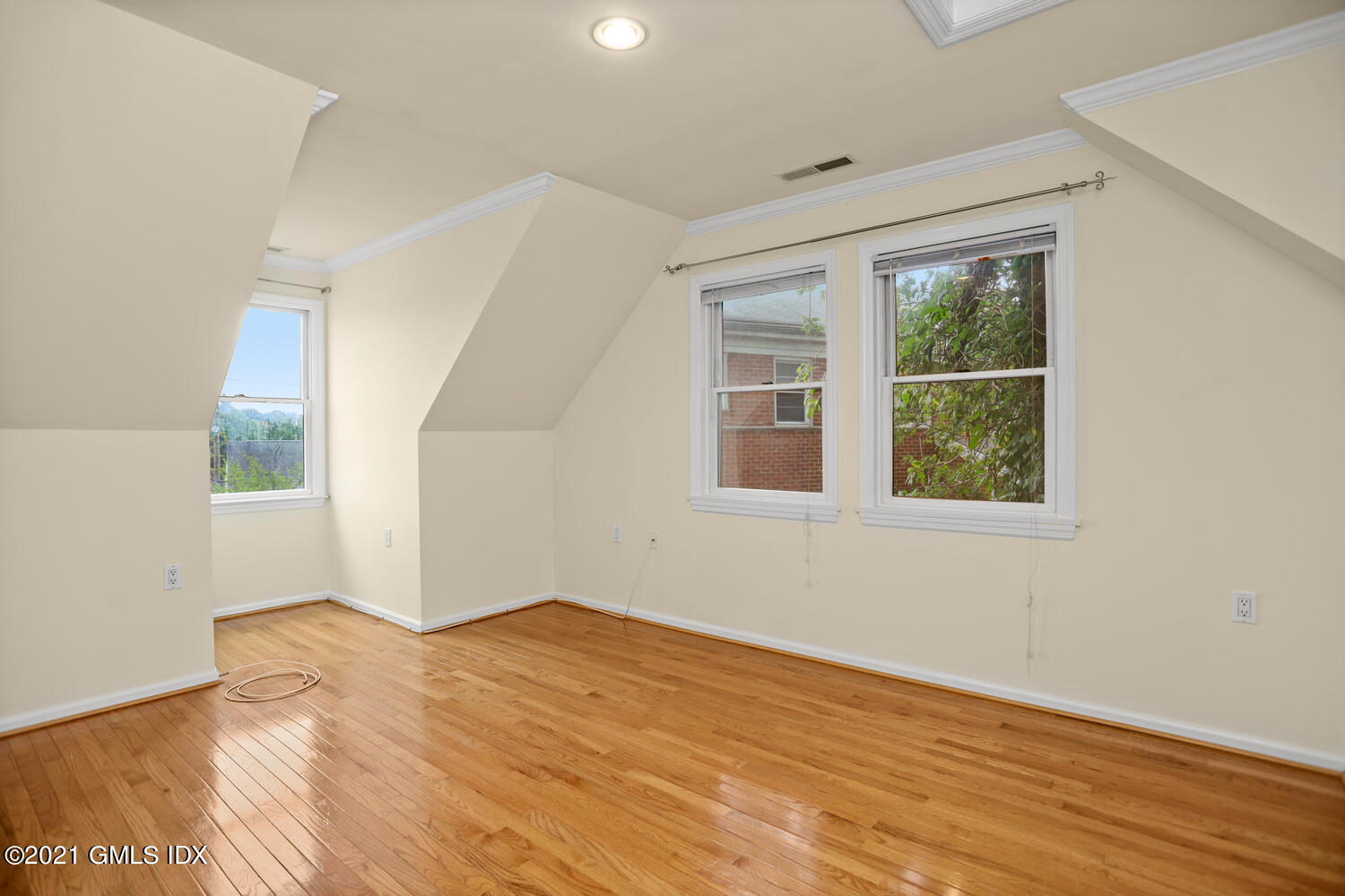 284 Glenbrook Road Stamford, CT 06906 - Photo 25 of 45 a view of empty room with wooden floor and fan