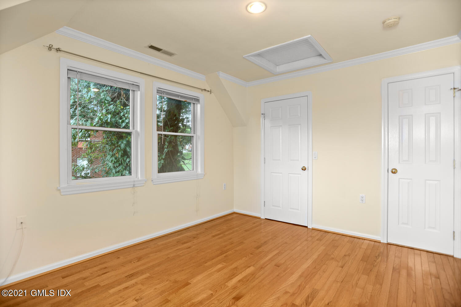 284 Glenbrook Road Stamford, CT 06906 - Photo 27 of 45 a view of empty room with wooden floor and fan