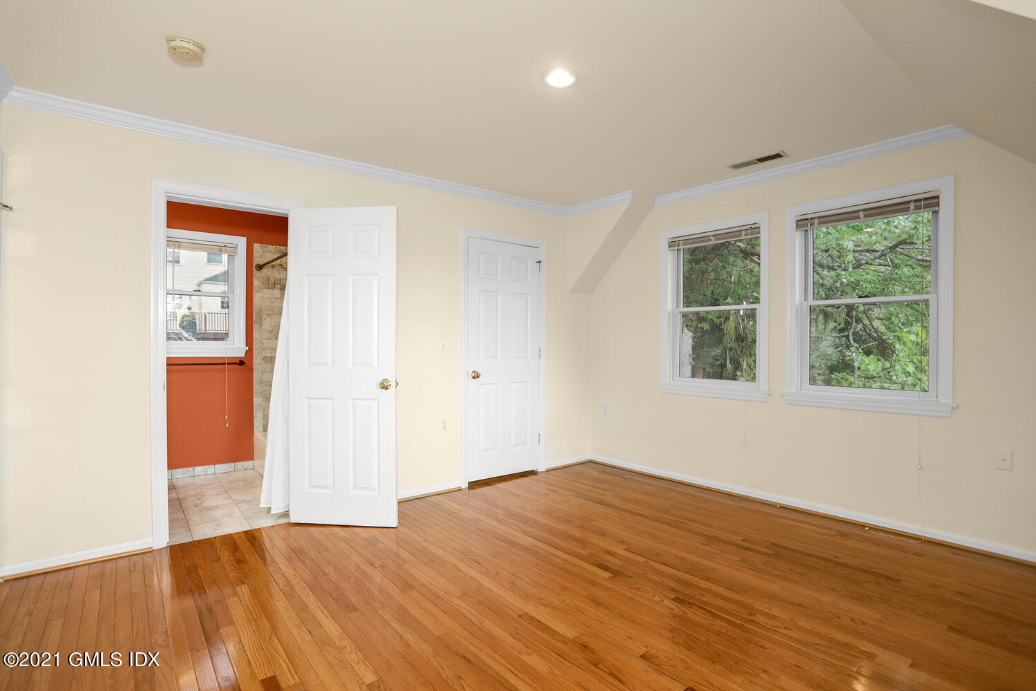 284 Glenbrook Road Stamford, CT 06906 - Photo 33 of 45 a view of empty room with wooden floor and fan