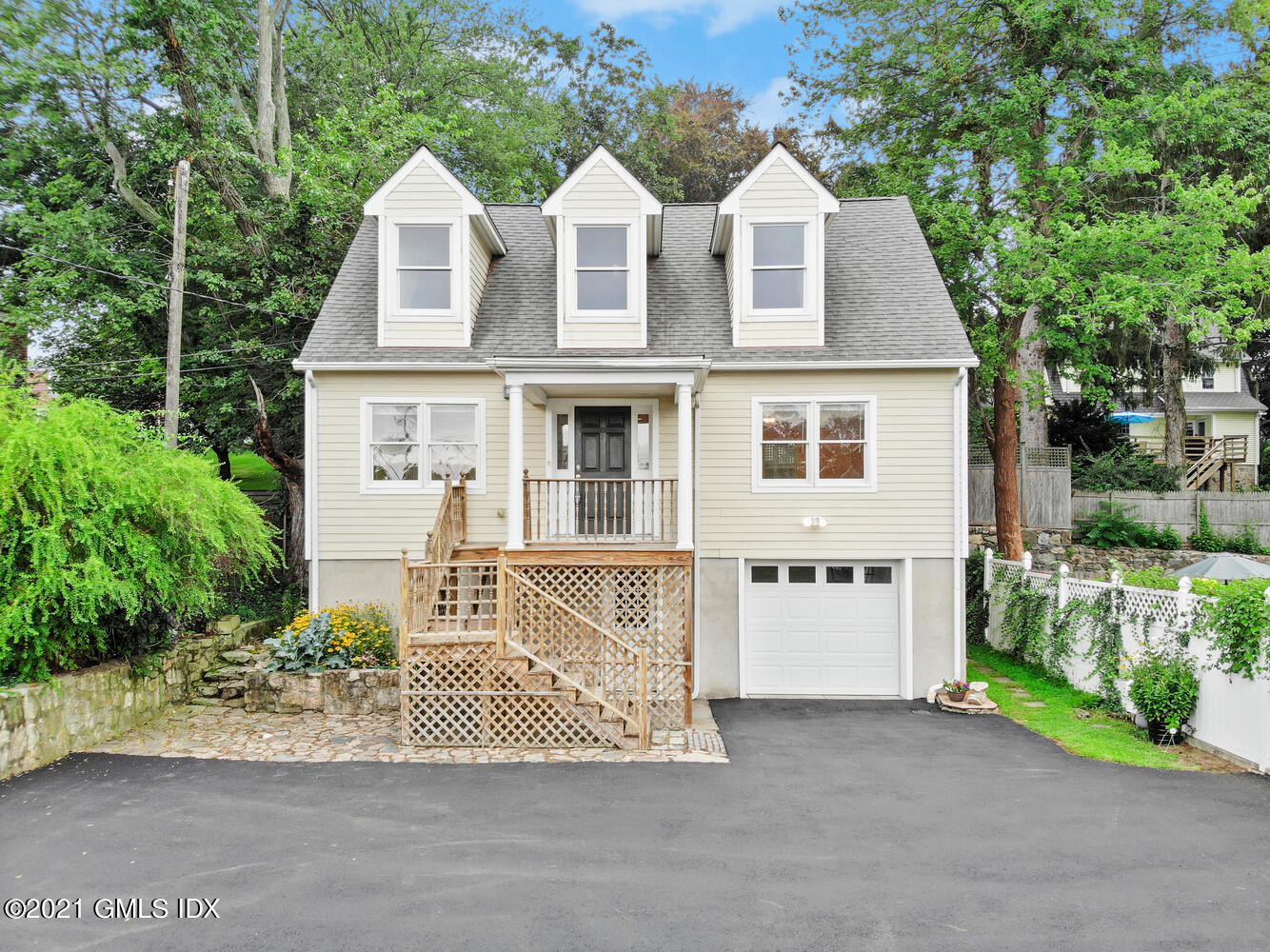 284 Glenbrook Road Stamford, CT 06906 - Photo 41 of 45 a view of a brick house with a yard and large trees