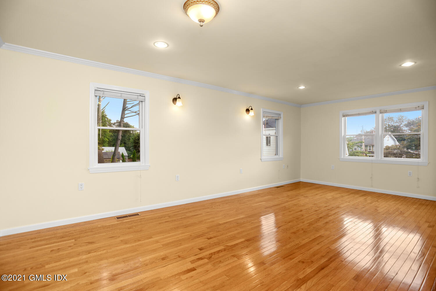 284 Glenbrook Road Stamford, CT 06906 - Photo 9 of 45 an empty room with wooden floor and windows
