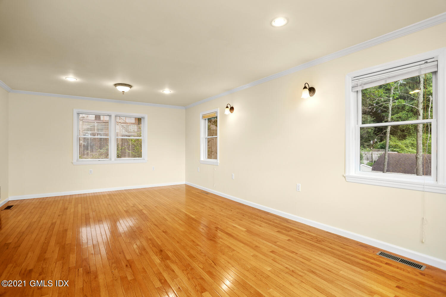 284 Glenbrook Road Stamford, CT 06906 - Photo 10 of 45 an empty room with wooden floor and windows