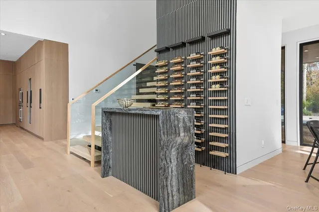 a kitchen with a stove a counter top space and living room view