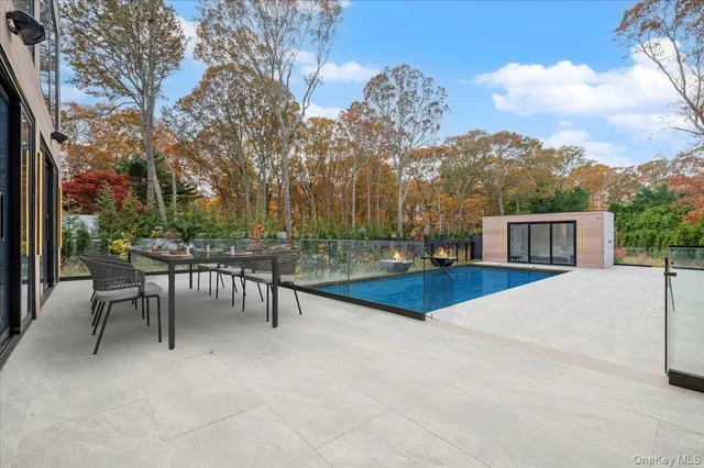a view of a house with backyard and a tree