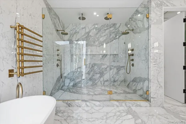 a bathroom with a granite countertop sink a toilet and shower