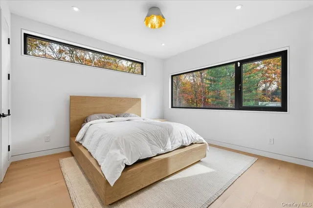 a bathroom with a sink toilet mirror and shower