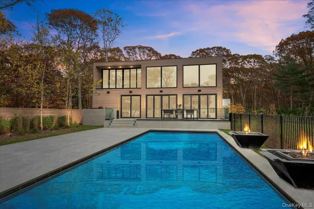 a view of a house with pool and a yard
