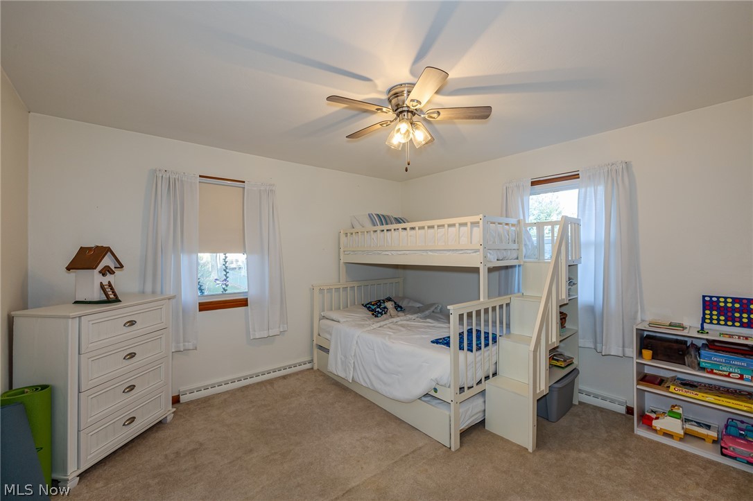 180 South Leavitt Road Amherst, OH 44001 - Photo 21 of 37 Bedroom featuring a baseboard radiator, a ceiling fan, and light carpet