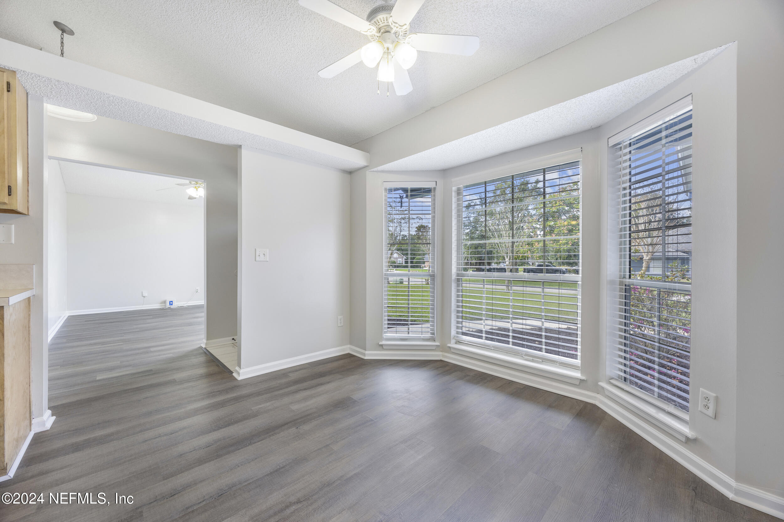 781 Nottingham Forest Circle St. Johns, FL 32259 - Photo 12 of 43 an empty room with wooden floor and windows