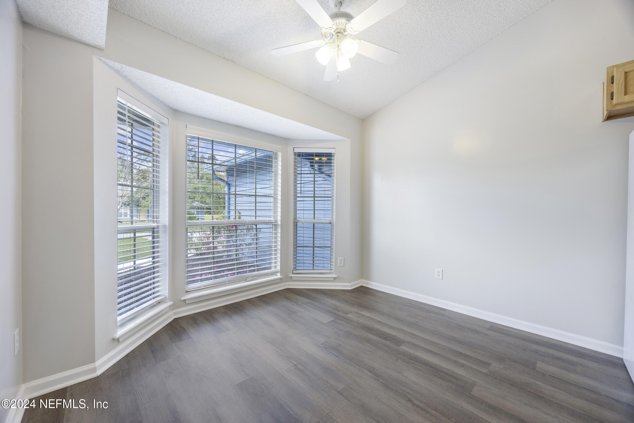 781 Nottingham Forest Circle St. Johns, FL 32259 - Photo 13 of 43 an empty room with wooden floor and windows