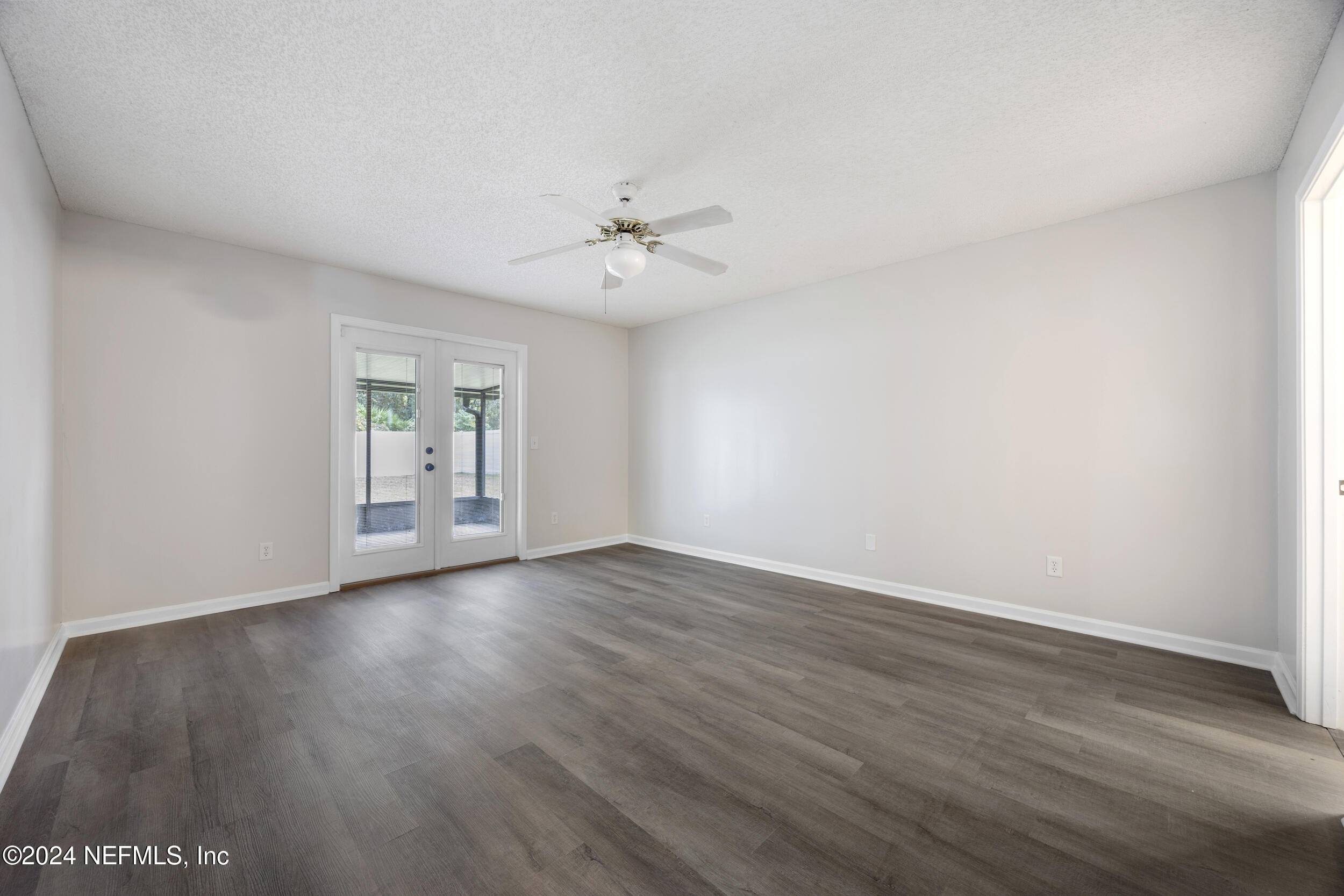 781 Nottingham Forest Circle St. Johns, FL 32259 - Photo 18 of 43 a view of an empty room with a window and wooden floor