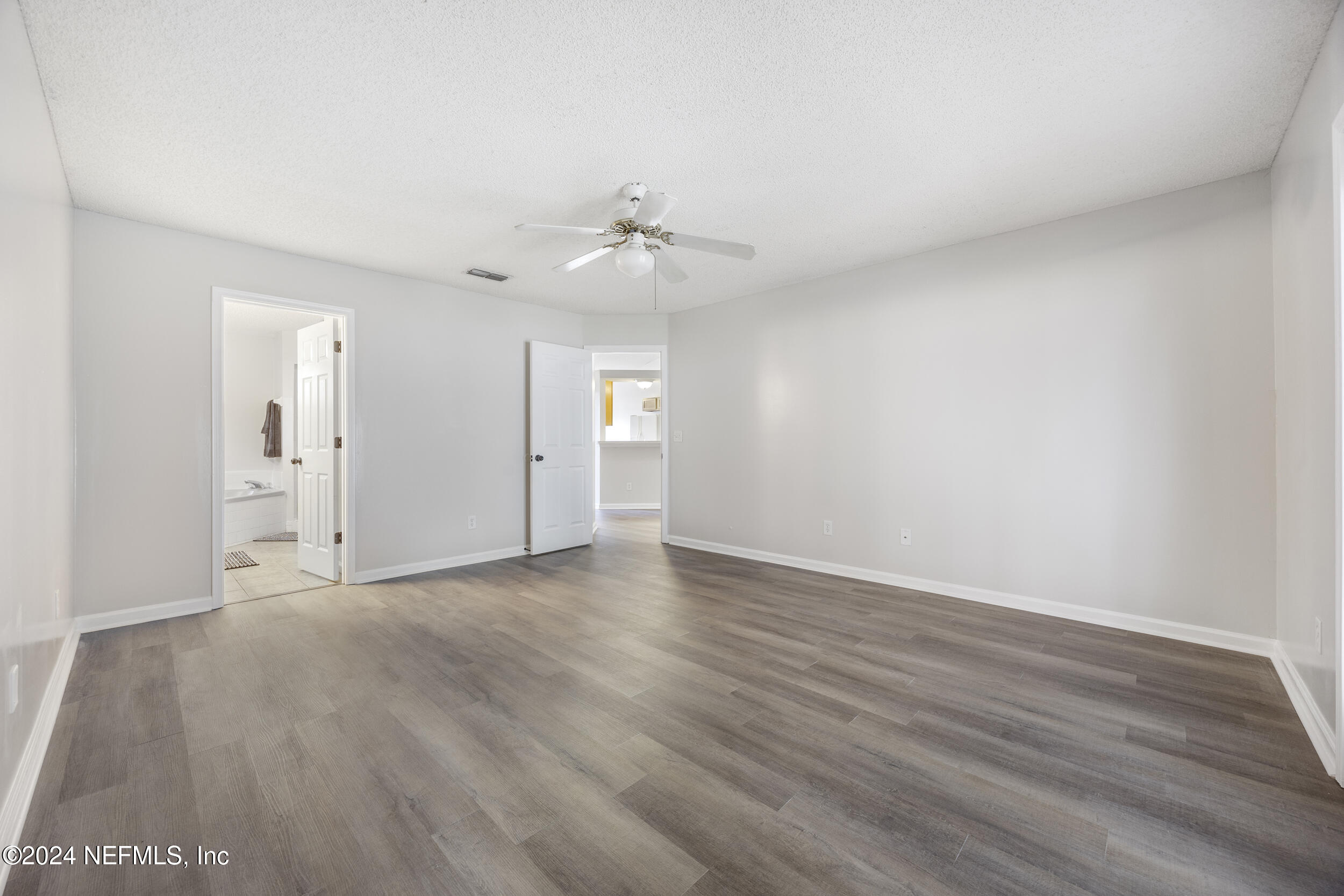 781 Nottingham Forest Circle St. Johns, FL 32259 - Photo 19 of 43 a view of an empty room with wooden floor and a ceiling fan