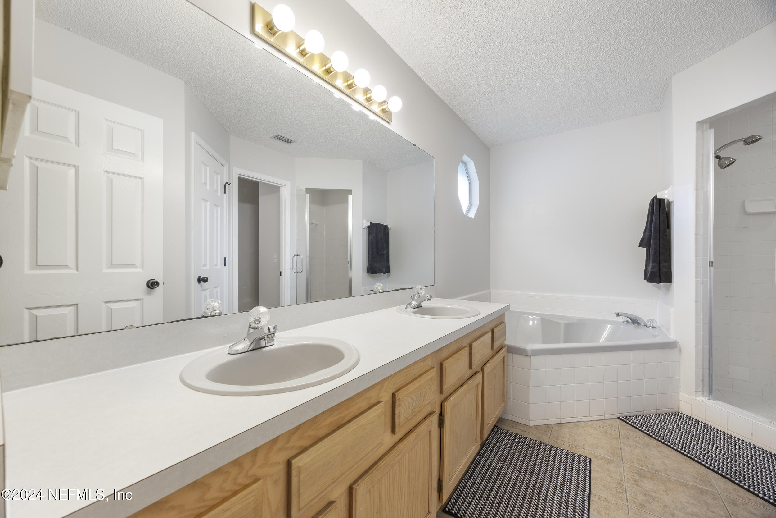 781 Nottingham Forest Circle St. Johns, FL 32259 - Photo 20 of 43 a bathroom with a sink double vanity granite tub and shower