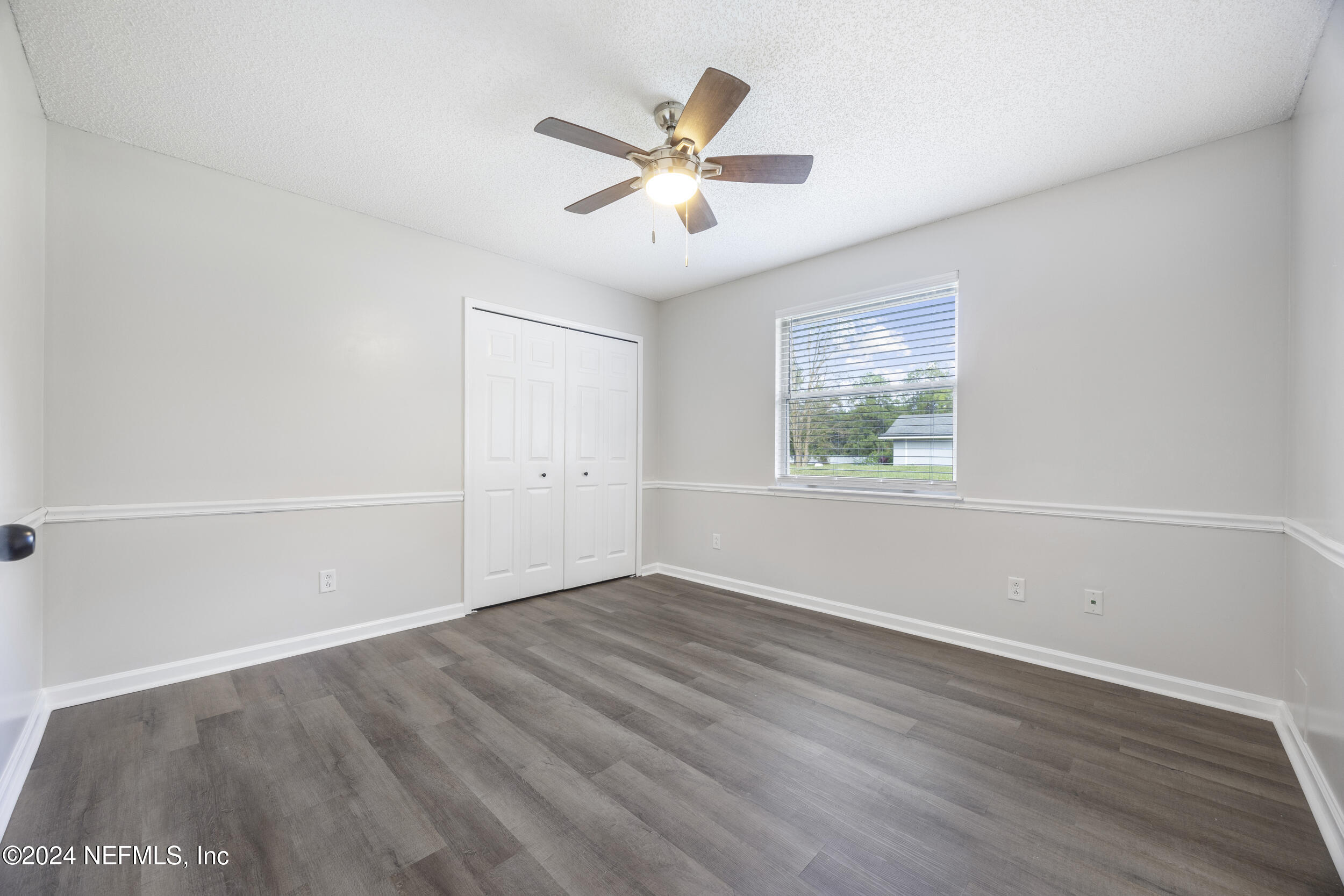 781 Nottingham Forest Circle St. Johns, FL 32259 - Photo 22 of 43 an empty room with wooden floor fan and windows