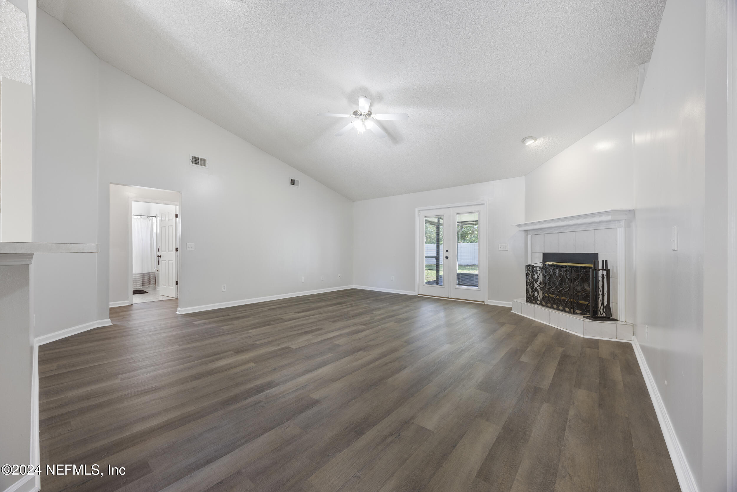 781 Nottingham Forest Circle St. Johns, FL 32259 - Photo 5 of 43 a view of empty room with wooden floor and fireplace