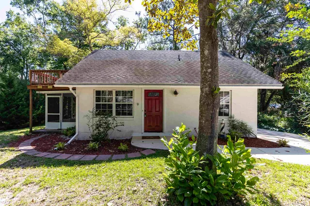 a front view of house with yard and outdoor seating
