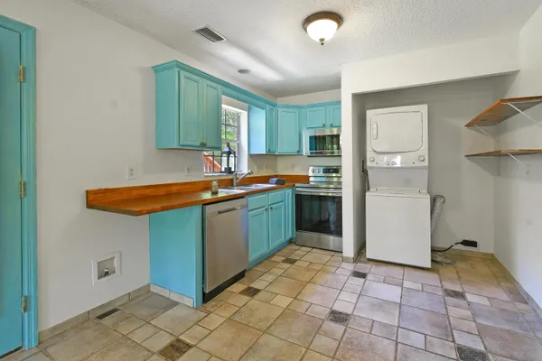 a kitchen with stainless steel appliances granite countertop a sink stove and cabinets