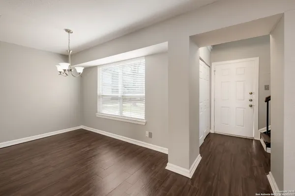 a view of a room with wooden floor and windows