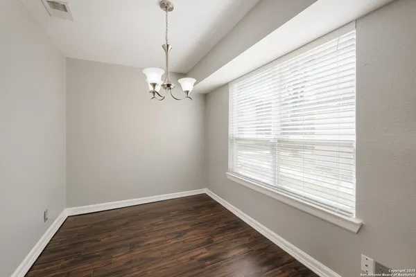 a view of a room with wooden floor and a window