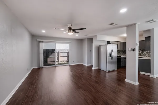 a view of an empty room with a kitchen