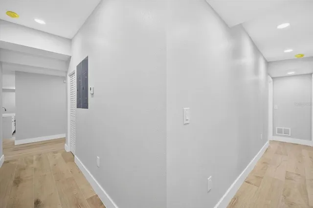 a view of hallway with a large window and closet