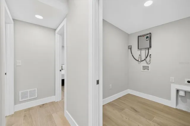 a view of a room with wooden floor and white walls
