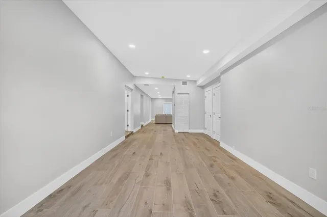 a view of empty room with wooden floor